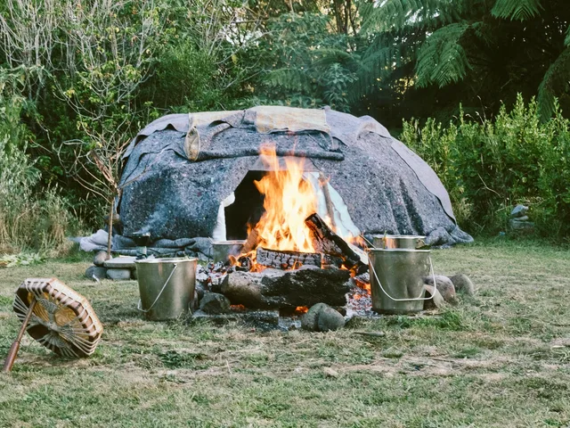 Fire and heated stones beside the sweat lodge