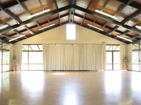 The light-filled workshop hall with a timber roof