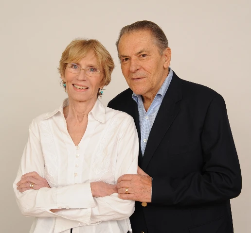 A couple standing together in a studio portrait